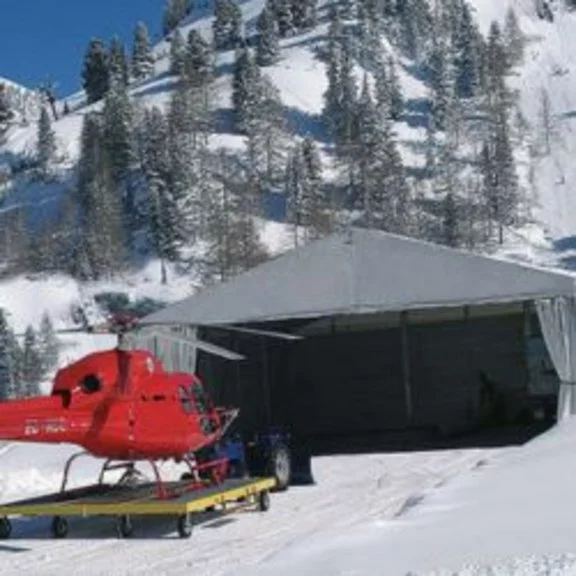 Red helicopter in front of a hangar built by RÖDER as an industrial tent